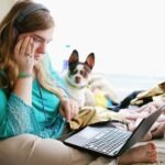 woman sitting at computer looking bored or frustrated